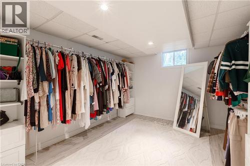 Dedicated room featuring extensive built-in garment racks, integrated shelving, and recessed lighting - 176 Riverbank Drive, Cambridge, ON 