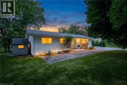 Ranch-style residence featuring white horizontal siding and a dark shingle roof - 176 Riverbank Drive, Cambridge, ON 