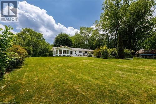 Expansive rear lawn with mature trees and established perimeter landscaping - 176 Riverbank Drive, Cambridge, ON 
