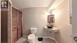 Bathroom featuring a corner vanity with mosaic tile accents, a vessel sink, and a framed mirror - 