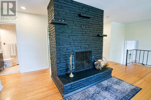 Wood burning fireplace with brick surround - 1430 Edgecliffe Avenue, Ottawa, ON 