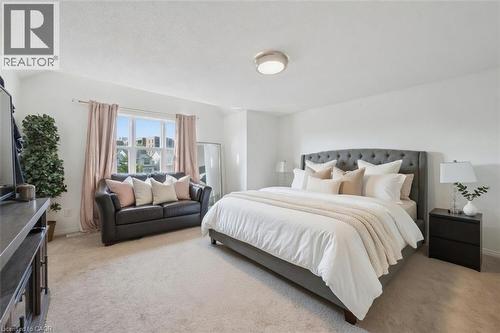 Spacious bedroom featuring light-toned carpeting, white painted walls, and a large window with ample natural light - 765 Angler Way, Waterloo, ON 
