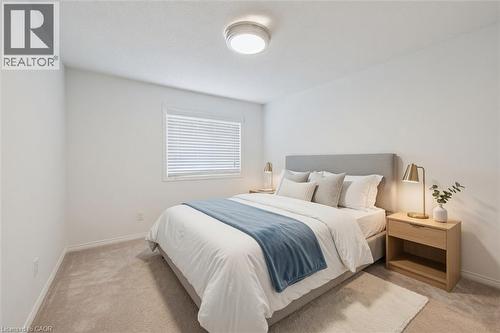 Bedroom with light neutral carpet flooring, a window with horizontal blinds, and a flush mount ceiling light fixture - 765 Angler Way, Waterloo, ON 