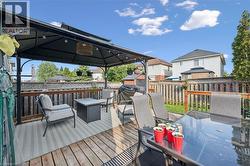 Expansive wood deck with a built-in gazebo featuring string lighting - 