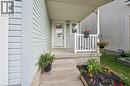 Inviting front entry featuring light blue horizontal siding - 765 Angler Way, Waterloo, ON 