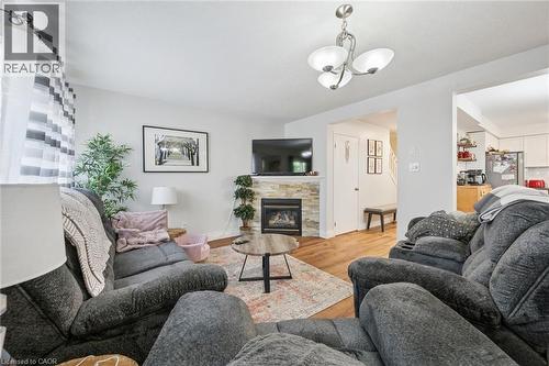 Living area with wood-finish flooring and light wall colors - 765 Angler Way, Waterloo, ON 