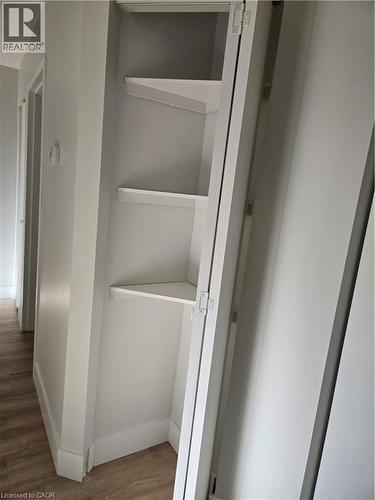 Built-in corner shelving unit with three white shelves - 3085 Kingsway Drive Unit# 21, Kitchener, ON 