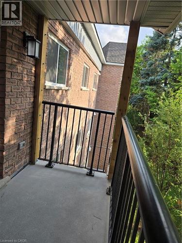Private balcony featuring a concrete surface, black metal railing, and a light-colored soffit - 3085 Kingsway Drive Unit# 21, Kitchener, ON 