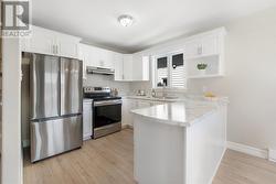Kitchen with lots of refreshed cabinets, new countertops and fridge - 