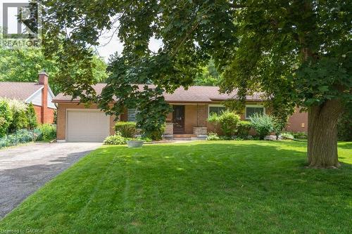 Brick exterior residence featuring a single-car garage and a paved driveway - 139 Mackay Crescent, Waterloo, ON 
