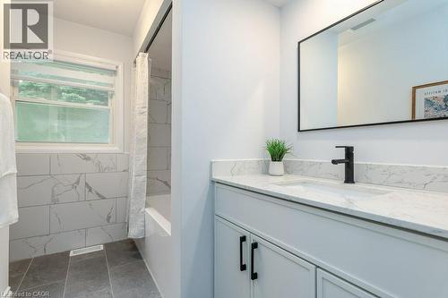 Bright bathroom featuring a white vanity with a light-toned countertop, an undermount sink, and a matte black faucet - 139 Mackay Crescent, Waterloo, ON - Indoor Photo Showing Bathroom