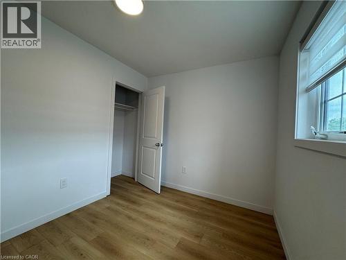 Bright room featuring wood-finish flooring and a white color palette - 113 Highriver Trail Unit# Main, Welland, ON - Indoor Photo Showing Other Room