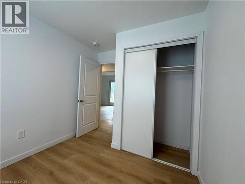 Room featuring wood-finish flooring, white walls, and a recessed ceiling light - 113 Highriver Trail Unit# Main, Welland, ON - Indoor Photo Showing Other Room