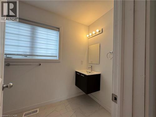 Modern floating vanity with a rectangular basin, chrome faucet, and integrated dark cabinetry - 113 Highriver Trail Unit# Main, Welland, ON - Indoor Photo Showing Bathroom