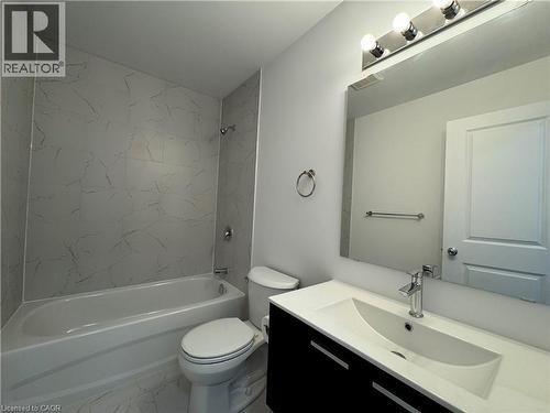 Bathroom featuring a modern vanity with integrated sink, chrome faucet, and rectangular mirror - 119 Highriver Trail Unit# Main, Welland, ON - Indoor Photo Showing Bathroom