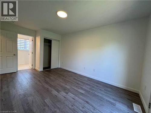 Spacious interior room featuring wood-finish flooring, recessed ceiling lighting, and crisp white walls - 133 Highriver Trail Unit# Main, Welland, ON 