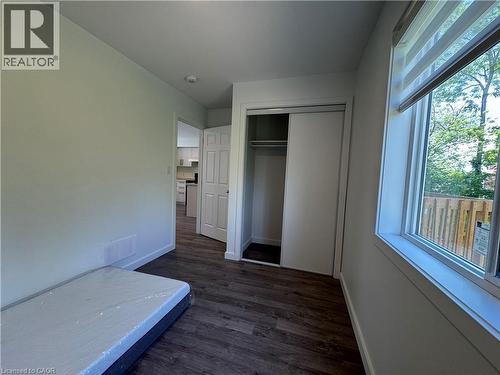 Bright interior room featuring wood-finish flooring, white walls, and a recessed ceiling light - 133 Highriver Trail Unit# Main, Welland, ON 