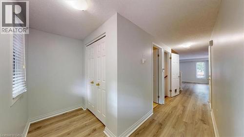 Hallway featuring wood-finish flooring, white trim, and light gray wall paint - 980 Creekside Drive, Waterloo, ON - Indoor Photo Showing Other Room