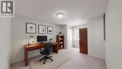 Light-filled room featuring neutral wall tones, carpeted flooring, a flush-mount ceiling light fixture, and a window providing natural illumination - 980 Creekside Drive, Waterloo, ON - Indoor Photo Showing Office