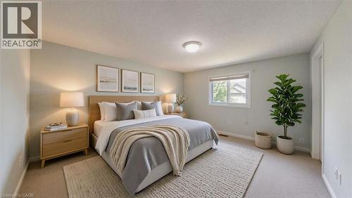 Bedroom featuring carpeting, light-toned wall paint, and a window with exterior views - Virtually staged - 980 Creekside Drive, Waterloo, ON - Indoor Photo Showing Bedroom