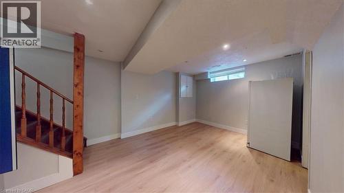 Spacious room with wood-finish flooring, recessed lighting, and light gray walls - 980 Creekside Drive, Waterloo, ON - Indoor