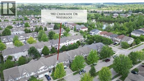 Aerial perspective of a residential neighborhood featuring rows of townhomes and detached properties - 980 Creekside Drive, Waterloo, ON - Outdoor With View