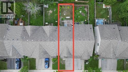 Aerial view showcasing the property's exterior, including a shingle roof, paved driveway, and a fenced backyard with varied landscaping - 980 Creekside Drive, Waterloo, ON - 