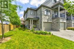 Stone and siding exterior with a covered front porch featuring square columns - 