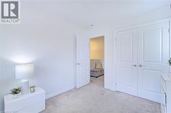 Neutral tone carpeted flooring with white baseboards - 