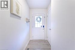 Entryway with wood-finish flooring and light-toned walls - 