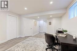 Versatile lower-level space featuring recessed lighting and durable wood-finish flooring - 