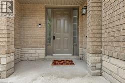Entryway featuring a solid panel door with two vertical sidelight windows - 