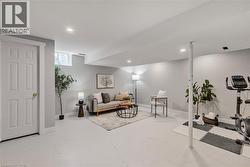 Spacious lower level featuring recessed lighting, a multi-pane window, white trim throughout, and a six-panel interior door - 