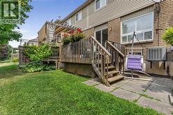 Multi-level rear wooden deck with pergola and privacy lattice - 