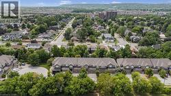 Townhome community featuring neutral-toned exteriors, attached garages, and pitched roofs - 