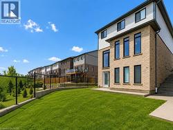 Contemporary multi-story exterior featuring light brick siding and black-framed windows - 