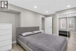 Spacious room featuring light-colored wood-finish flooring and recessed lighting - 