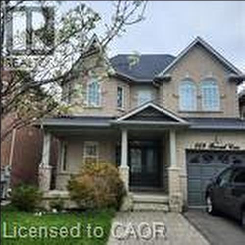 Traditional-style two-story home featuring a brick and stucco facade, an attached garage, and a covered front porch with stone-clad columns - 249 Bussel Crescent, Milton, ON 