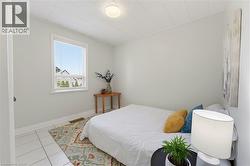 Bright room featuring white tile flooring and light-toned walls - 