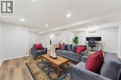 Finished lower level with wood-finish flooring and recessed lighting - 