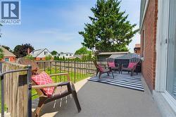 Outdoor patio space featuring a concrete surface, red brick exterior, and white framed glass doors - 
