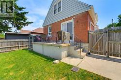 Red brick exterior featuring light blue siding and a raised concrete patio - 