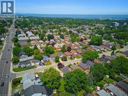 Expansive aerial capturing a residential area with a prominent multi-lane thoroughfare - 