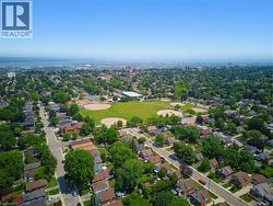 Aerial perspective showcasing a residential neighborhood with a large central park - 