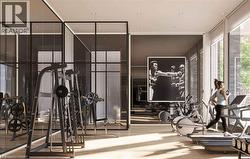 Dedicated fitness facility featuring wood-finish flooring, recessed lighting, expansive windows, and glass partition walls - 