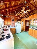 Kitchen has pine cupboards and white counters - 