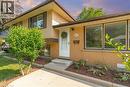Split-level residence featuring a brick facade with horizontal siding accents - 64 Warren Road, Kitchener, ON 
