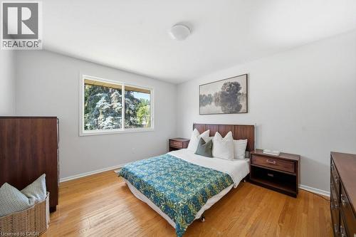 Bright room featuring wood flooring, a contemporary window, and a flush-mount ceiling light - 64 Warren Road, Kitchener, ON 