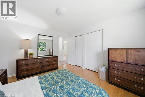 Bright interior space featuring light wood flooring, white walls, and a round flush-mount ceiling light - 64 Warren Road, Kitchener, ON 