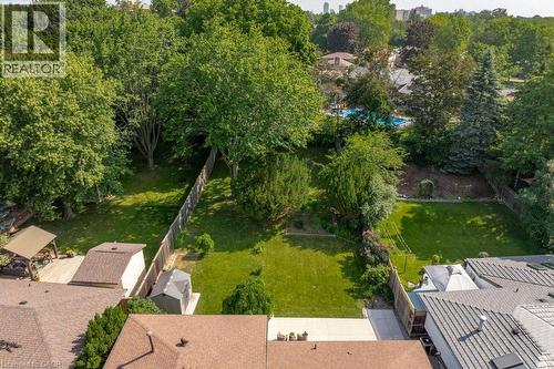 Spacious backyard with extensive green lawns and mature trees - 64 Warren Road, Kitchener, ON 